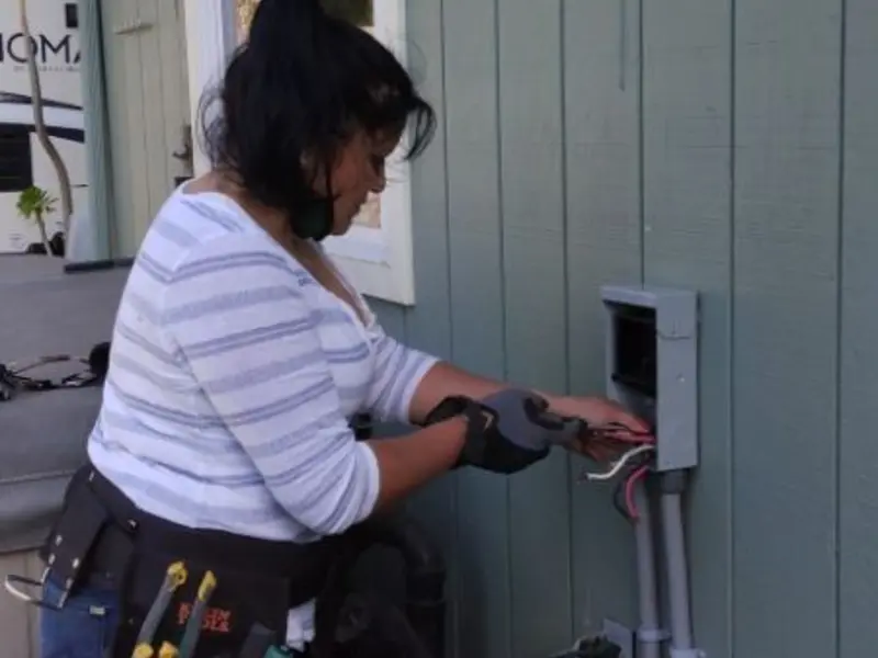 Licensed electrician wiring an exterior subpanel in Gunnison