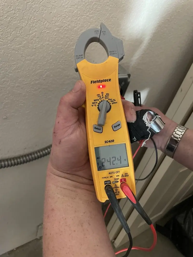 Voltage testing with clamp meter during Recessed Lighting Installation in Gunnison